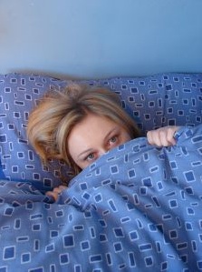 Girl in bed under duvet